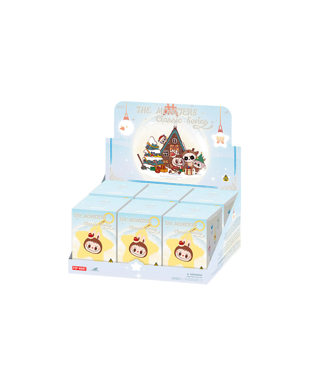 Caja rectangular azul claro con dibujo frontal de una estrella amarilla sonriente con cara de Labubu. Incluye colgante‑peluche brillante en forma de estrella amarilla con cabeza marrón redondeada, orejitas monstruosas, cuernitos pequeños y un lazo rojo en la parte superior junto a la anilla para colgar.